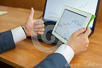 The close-up of diagram on the tablet in manâ€™s hands. Stock Photo